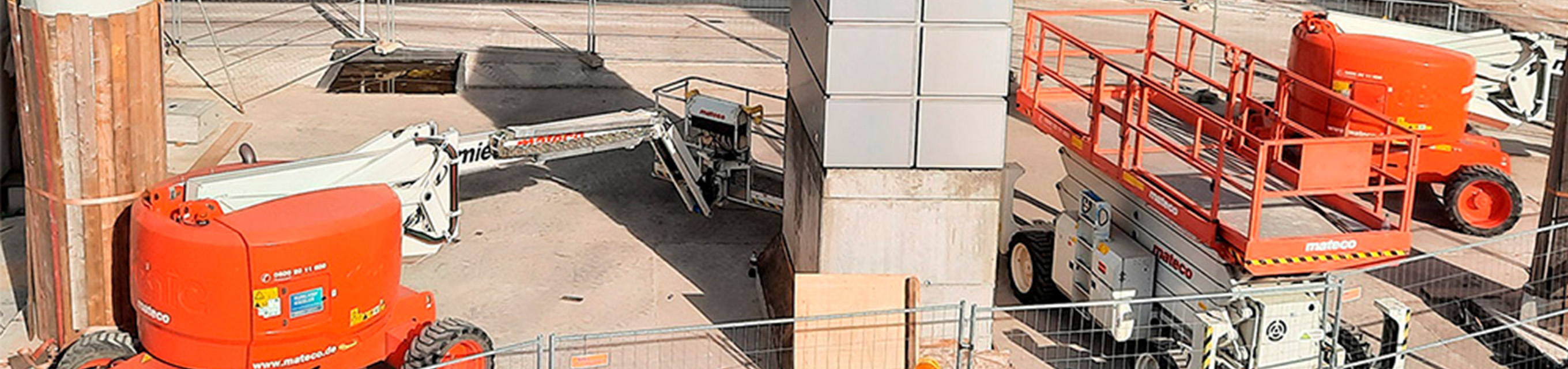 Neue Schulung – Jährliche Unterweisung für Bediener von Hubarbeitsbühnen Baustellenfahrzeuge inklusive Hubarbeitsbühnen arbeiten am Bau eines neuen Gebäudes.